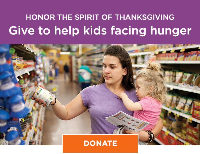 A mom holding her toddler on her hip while standing in a grocery store aisle, picking up a can from a shelf. She has a serious expression on her face. A headline reads: Honor the spirit of Thanksgiving. Give to help kids facing hunger. A button reads: Donate
