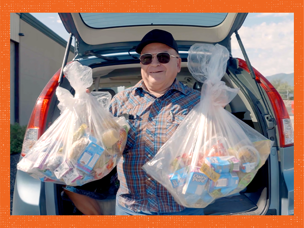 Jose with bags of packaged food